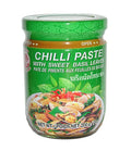 A jar of Cock Brand Chili Paste with Sweet Basil Leaves, 200g, with product information and branding visible on the label.
