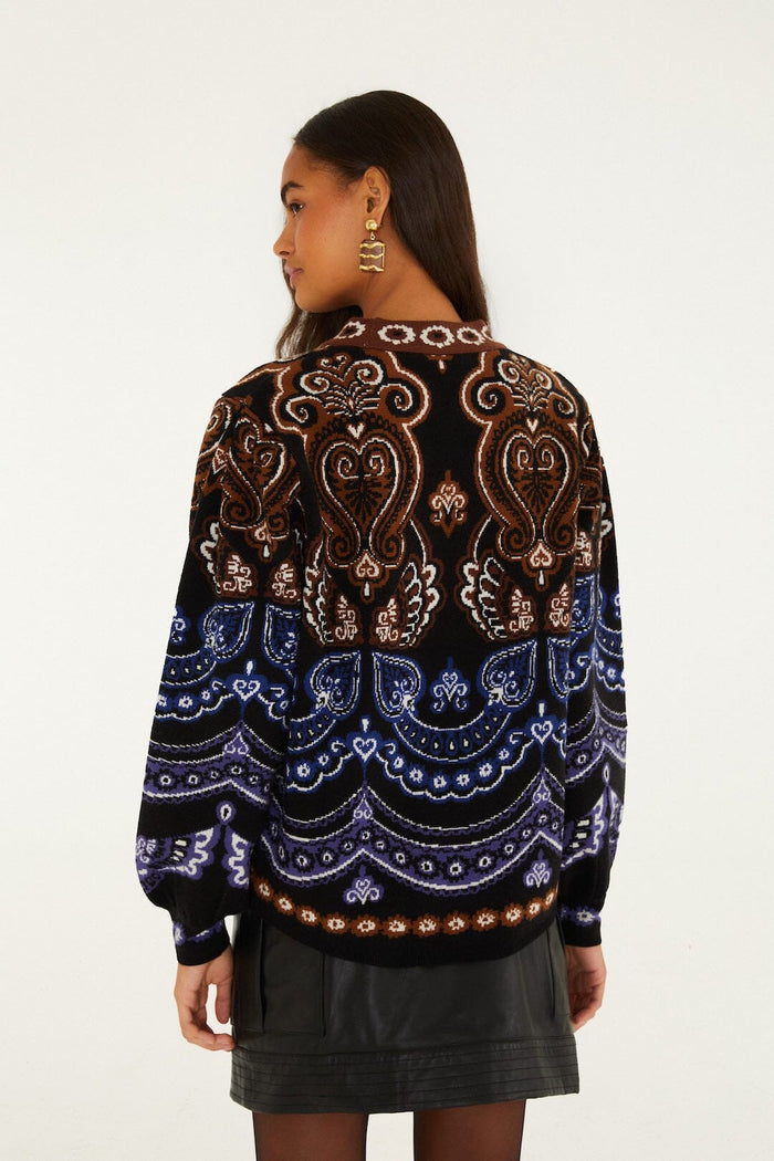 FARM Rio model wearing the Nicole Scarf Puff Sleeve Knit Sweater