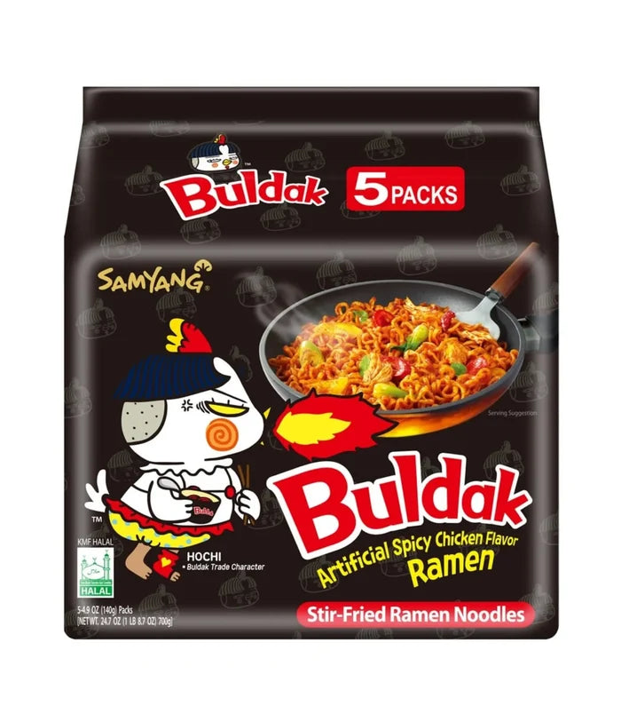 Packaging for Samyang Spicy Chicken Buldak Noodles showing an illustration of a character eating noodles and the text indicating it is a product of Korea, containing 5 packs, and is a stir-fried ramen noodle.
